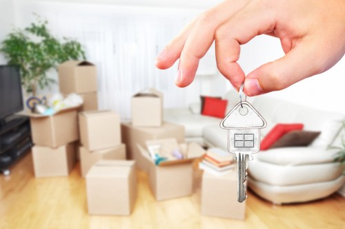 Professional movers carrying furniture from a flat in Belsizepark