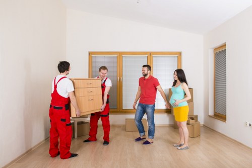 Local moving team navigating stairs in a Belsizepark period property