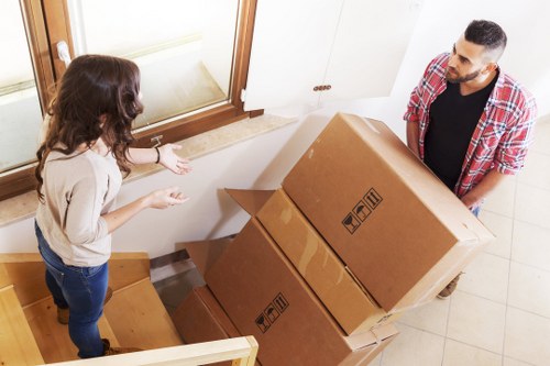 Removal crew handling furniture in a Belsize Park apartment building