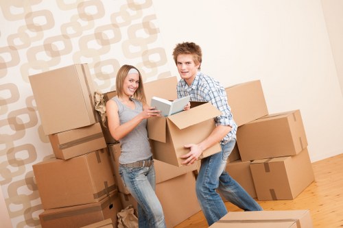 Local moving team organizing items for transport in Belsizepark